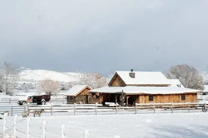 Snow-covered ranch home with barn and horses in Heber City, Utah, where we provide house cleaning services